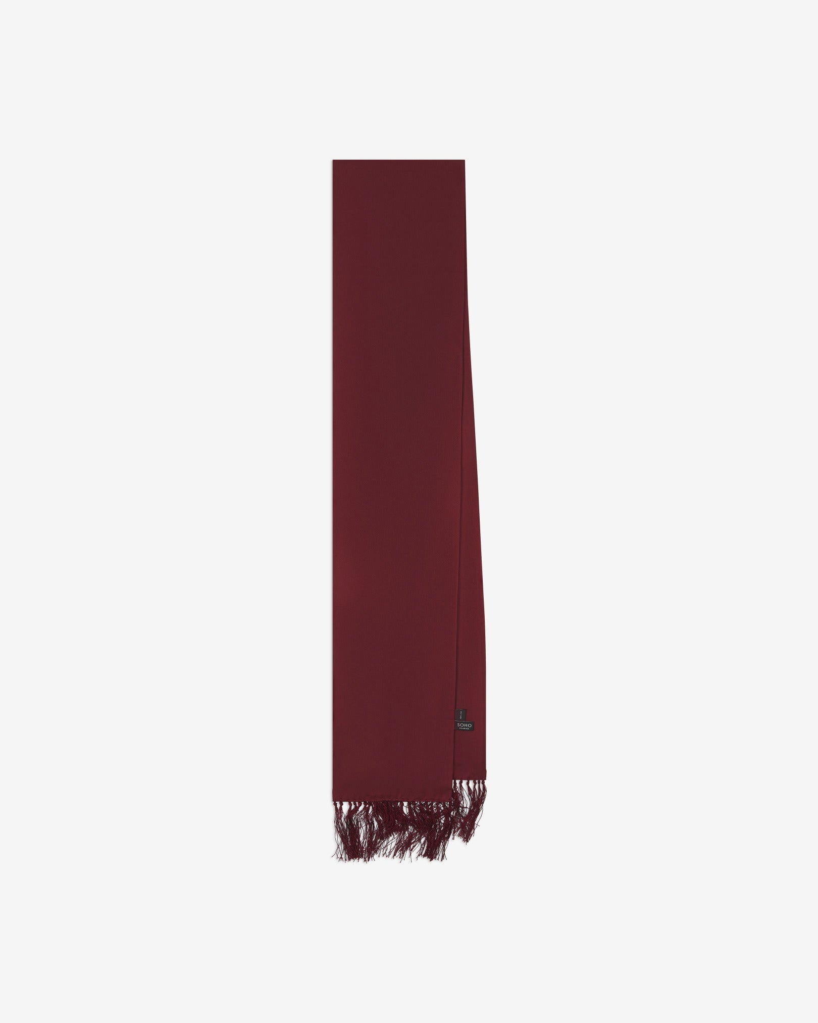 The wine-red silk aviator scarf folded and presented vertically illustrating the full scarf dimensions and matching wine-red fringes.