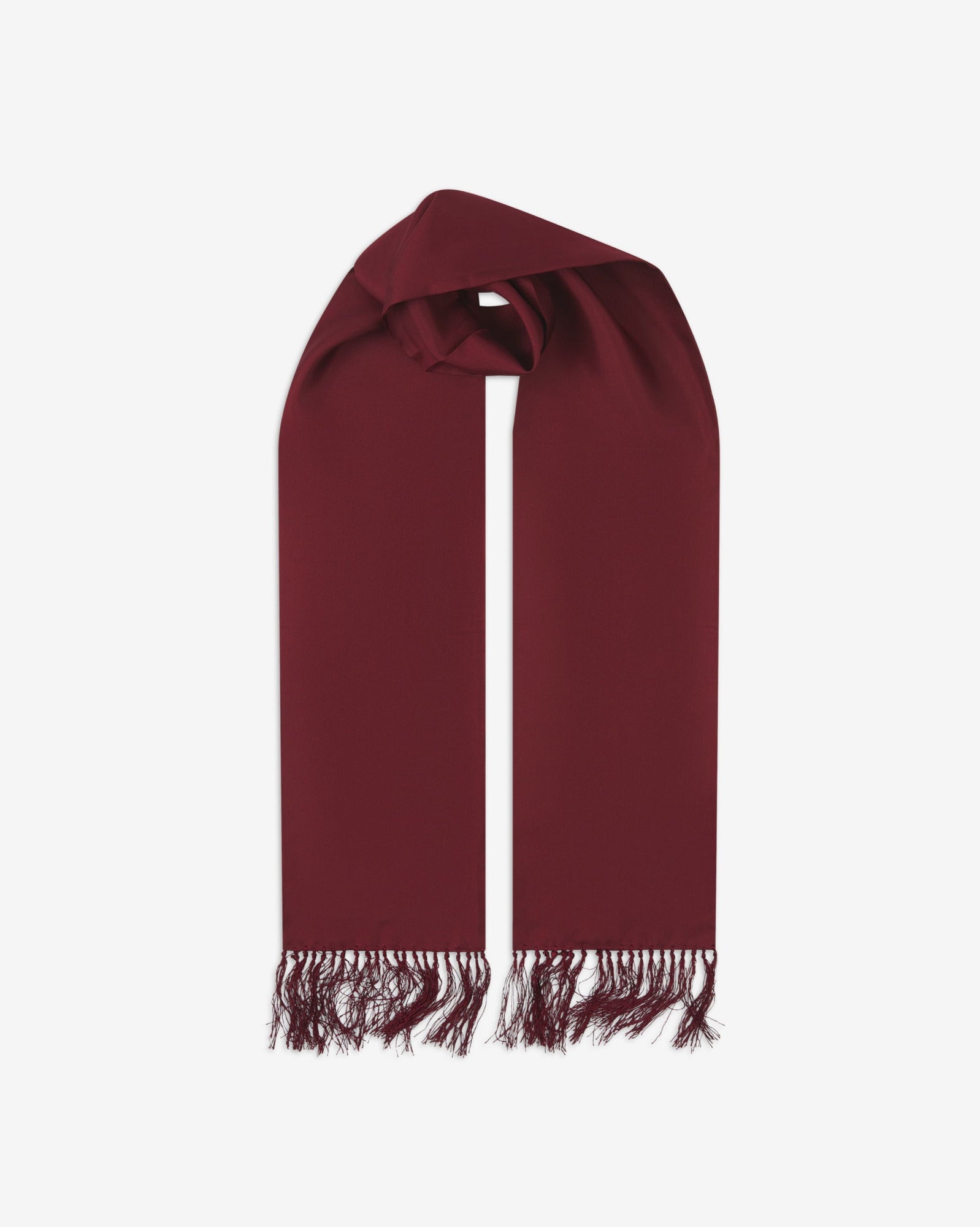 Wine-red silk aviator scarf from Soho Scarves. Looped with both ends parallel showing the branding label to the right and the matching 8cm long fringes.