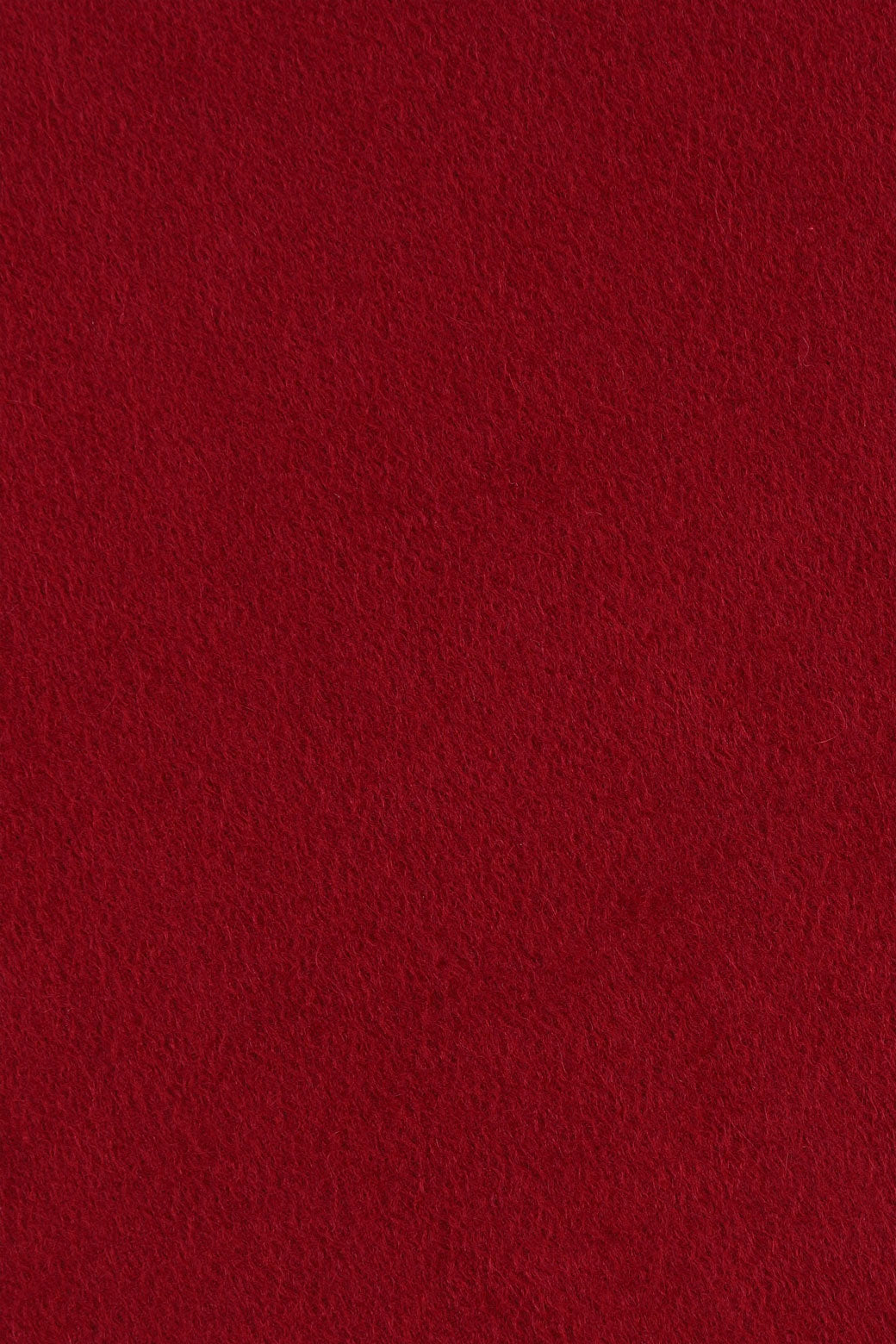 Close range view of red-maroon cashmere scarf from Soho Scarves, showing individual fibres and texture of soft material.