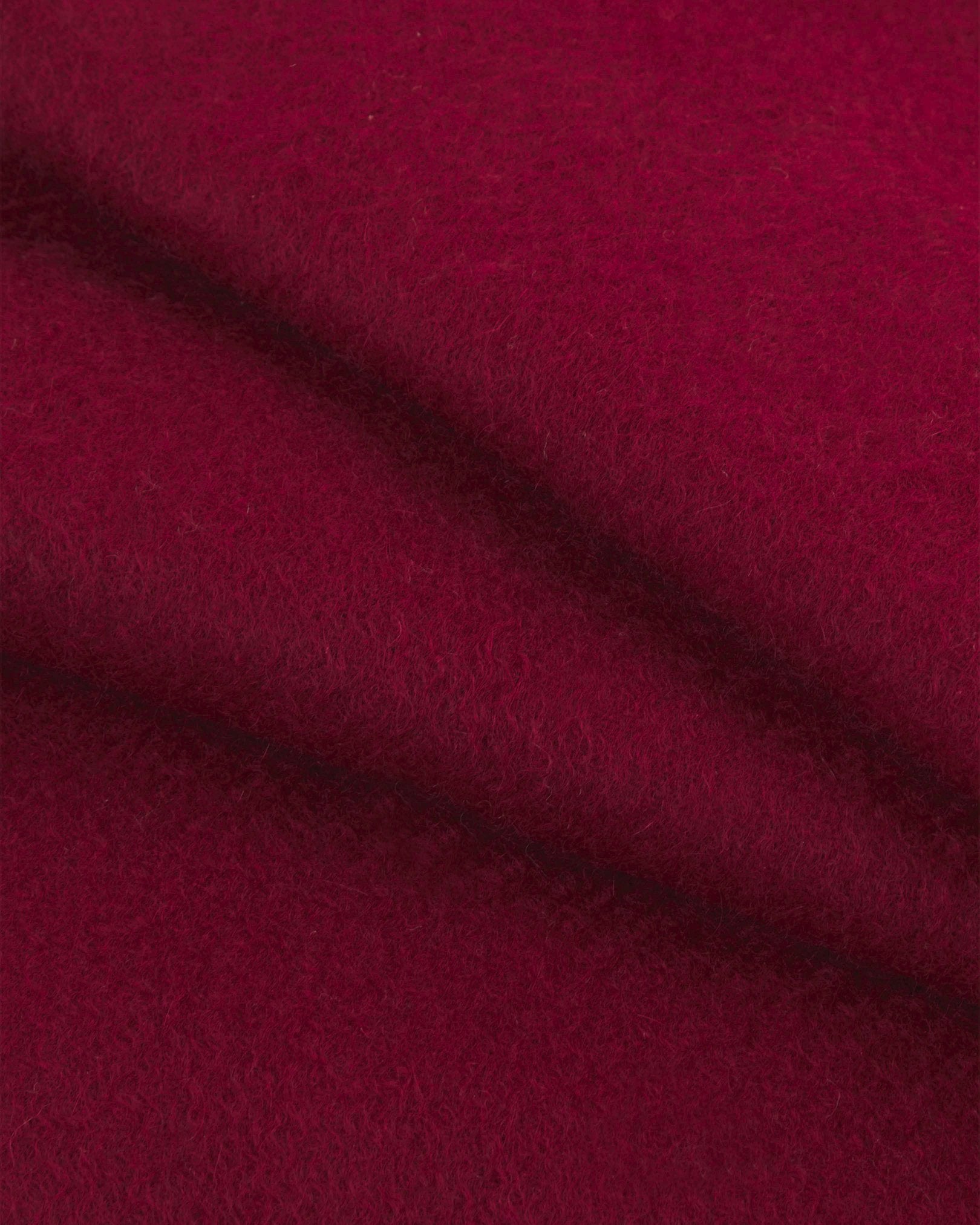 Close range view of wine-red cashmere scarf from Soho Scarves, showing individual fibres and texture of the luxurious material.