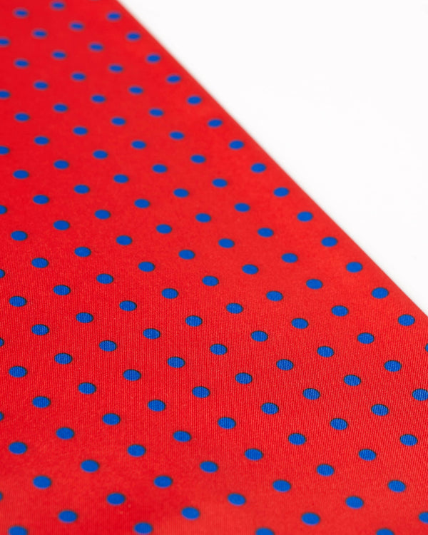 Angled view of the red and blue polka dot scarf.