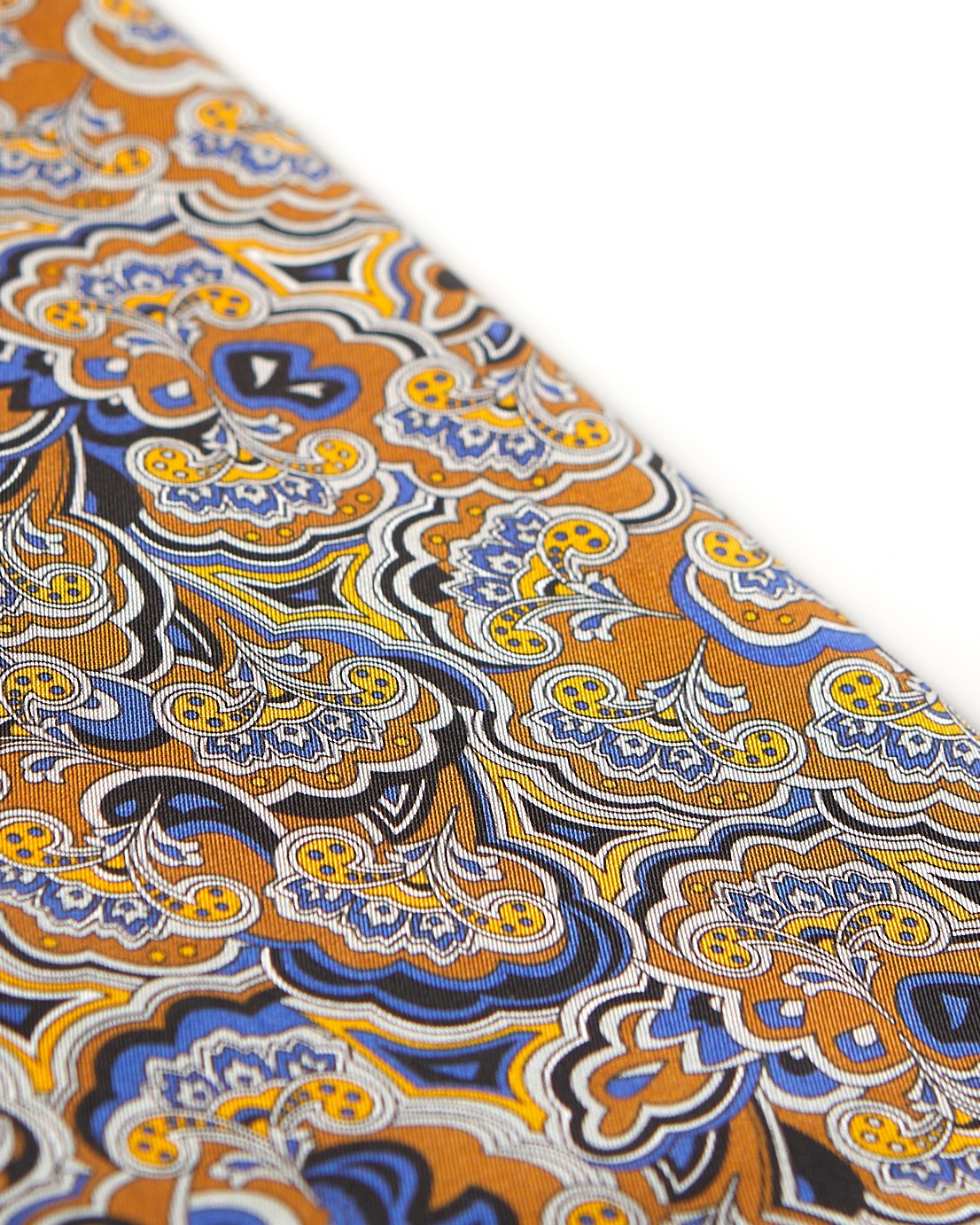 Angled view of the scarf, focussing on a segment of the paisley-inspired patterns in blue, orange, yellow, black and white.