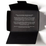 Opened black packaging for wool pocket square from Soho Scarves, containing style manifesto.