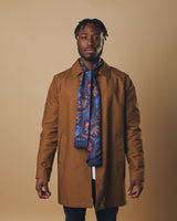 Modelling 'The Kemp' dark-blue silk and wool paisley dress scarf paired with tan three quarter length coat. 