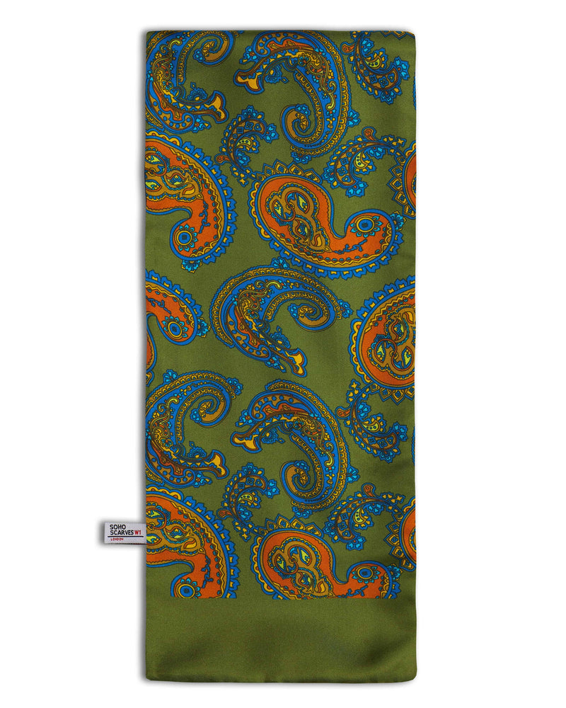‘The Carlisle’ wool backed scarf arranged in a rectangular shape, clearly showing the multi-coloured paisley patterns, deep green border and the ‘Soho Scarves’ label on the left edge.