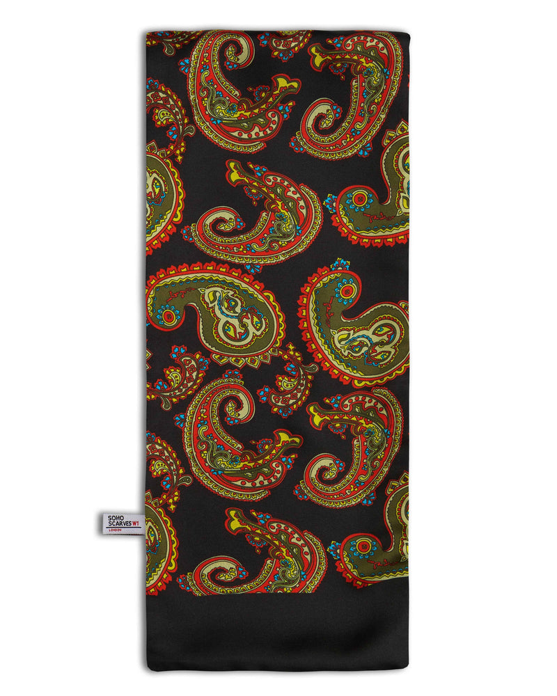 The Portland' black wool backed scarf arranged in a rectangular shape, clearly showing the multi-coloured paisley patterns, black border and the 'Soho Scarves' label on the left edge.