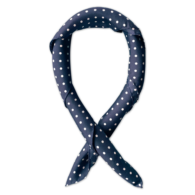 Square scarf rolled into a loop, showing the fabric sheen of the classic dark-blue and white spotty silk fabric